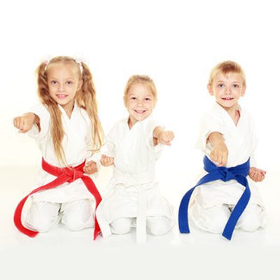 Children practicing martial arts in uniforms.
